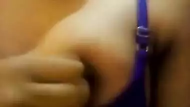 Wife in a blue sex bra takes a XXX Indian tit out and squeezes it